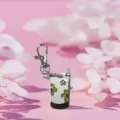 Cute mini flip phone pocket watch keychain with floral pattern, vintage metal bag charm. - White