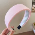 Close-up detail of a pink ribbed wide headband showcasing soft texture and padded profile. - Pink Ribbed Knit Style