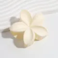 Detail view of the elegant white plumeria flower hair claw clip, perfect summer accessory. - Matte Ivory White