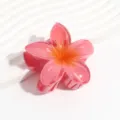 Detailed close-up of a pink jelly-color plumeria flower hair claw clip, translucent resin texture. - Frangipani Red
