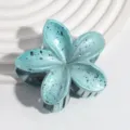 Detailed view of the blue pearl frangipani flower hair claw clip, fashion summer accessory. - Metallic Sky Blue