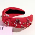 Detail shot of red padded knot headband with pearls and crystal hearts for women. - Red Pearl Rhinestone Heart