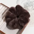 Brown fluffy faux fur hair scrunchie detail view, soft plush elastic hair tie accessory. - Brown