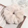 Fluffy faux fur hair scrunchie detail view, soft plush large hair tie for women and girls. - Beige