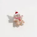 Detalle en primer plano de una pinza de pelo de jengibre navideño con purpurina dorada. - Hombre de Jengibre con Purpurina