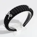Detail view of the black polka dot headband with elegant pearl bow accents, exquisite craftsmanship. - Polka Dot Bow Black