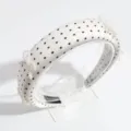 Detailed view of white polka dot headband featuring elegant pearl bows for charming styling. - Polka Dot Bow White