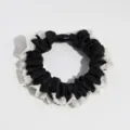 Elegant black satin scrunchie featuring delicate white lace trim and a stylish center black bead. - Black
