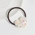 Detail view of a minimalist heart-shaped resin hair tie featuring colorful crystal rhinestones. - White Heart