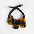 Close-up detail of tortoiseshell Scottie dog hair rope with rhinestone accents on black cord. - Yellow Black Dog