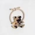 Detailed close-up of a chic tortoiseshell resin bear hair tie with golden metallic ends. - Yellow Black Bear