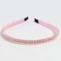 Pink crystal rhinestone headband detail close-up showing sparkly beaded hair accessory. - Pink