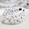 Detailed shot of the black and white floral knotted hair hoop, showcasing fabric texture. - Knotted Butterfly Style / White