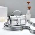 Silver metallic top handle handbag for women with wide patterned strap and trendy design. - Silver