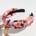 Close up detail shot of pink Halloween knotted headband with ghost and cat print fabric. - Pink