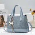 Stylish blue denim texture handbag with PU leather trim, tote bag with cute rocking horse charm. - Blue