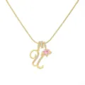 Detailed close-up of the elegant gold alphabet pendant necklace with pink heart and zircon. - Letter U