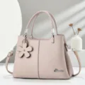 Borsa a mano in pelle PU con motivo litchi rosa con ciondolo floreale e dettagli argentati. - Rosa