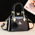 Borsa a mano in pelle verniciata nera con dettagli dorati, chiusura in cristallo e fiore. - Caffè