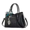Elegant black leather embossed handbag for women, featuring a chic scarf and leaf pendant. - Black