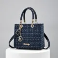 Blue tweed top handle shoulder bag with classic quilted design and elegant metal chain charm. - Blue