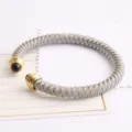 Bracelet Jonc Acier Inoxydable Câble Tressé Embouts Dorés et Perles Noires Tendance - Bicolore (Or & Argent)
