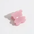 Close-up detail shot of a cute pink mini bear claw clip showing translucent resin texture. - Pink