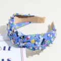 Blue knotted headband with pearls and school print, stylish hair accessory for daily wear. - Blue