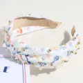 Fashion wide brim knotted headband with back-to-school print, pearl and gold bead accents. - White