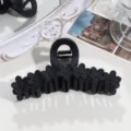 Close-up detail of black matte floral hair claw clip, elegant daily hair styling accessory. - Bar Flower / Black