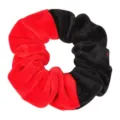 Velvet hair scrunchie detail view, showing the soft red and black color-blocked fabric texture. - Red & Black