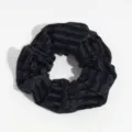 Detailed close-up of a black velvet hair scrunchie showing soft striped fabric texture. - Black Striped