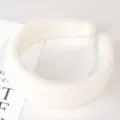 Close-up detail of a soft white plush headband, fluffy winter and spring hair hoop accessory. - Plush White