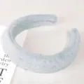 Close-up of soft plush headband in light blue, fluffy faux fur texture for high cranial top. - Plush Blue