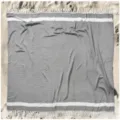Grey Turkish cotton beach towel flat lay detail with white stripes and elegant fringe accents. - Light Gray