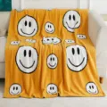 Cozy yellow knitted throw blanket with cute white smiley face pattern, soft fleece fabric. - Big Smiley Face - Yellow