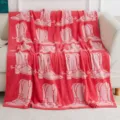 Soft knitted sofa blanket with pink cowboy boot pattern, cozy home textile detail view. - Fuchsia Boots