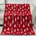 Detailed view of a cozy red Christmas knit blanket featuring white festive tree patterns. - Christmas Tree - Red