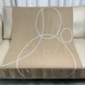 Beige knitted throw blanket with modern white geometric circle pattern for cozy sofa living room decor. - Knit Jacquard / 100x150cm