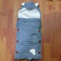 Detailed view of the cute knitted baby sleeping bag, featuring warm fleece lining and cozy hood. - Grey Blue Fleece Lined