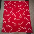 Red Christmas knitted throw blanket featuring classic white candy cane pattern for holiday decor. - Red Candy Cane