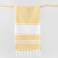 Detailed shot of yellow and white striped Turkish beach towel hanging on wood, tassel detail. - 100*180cm + Tassels 10*2cm (350g) / Yellow