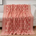 Coral pink woven blanket with traditional floral medallion pattern, perfect for sofa and bed. - Orange