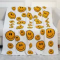 Cozy white fleece throw blanket with trendy yellow distorted smiley face pattern for sofa. - Big Smiley Face - White