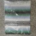 Woven Mexican blanket detail view showing geometric stripes and fringe design, soft cotton fabric. - MC Grey Green