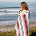 Woven Mexican blanket with geometric patterns and tassels, ideal for beach, picnic and yoga use. - Light Green and Pink
