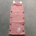 Pink knitted baby sleeping bag with cute ears, soft newborn swaddle blanket for stroller use. - Cinnamon Pink