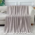 Cozy knitted fleece blanket draped on sofa, soft textured home decor throw for living room. - Soft Fluffy Blanket - Oatmeal