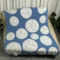 Detail shot of soft blue knitted throw blanket featuring white volleyball pattern for cozy sofa decor. - 127x152cm - 900g / Volleyball - White and Blue