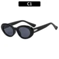 Gafas de sol ovaladas retro negras para mujer, elegante estilo francés con detalles metálicos. - Negro Brillante